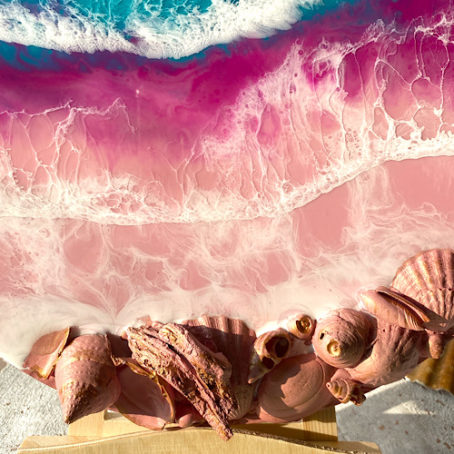 close up of pink shells on abstract shoreline wall art